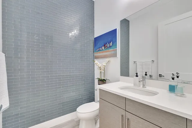 a large kitchen with kitchen island a large counter top space a sink stainless steel appliances and cabinets