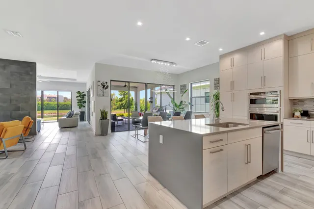 a kitchen with stainless steel appliances granite countertop white cabinets a sink and dishwasher