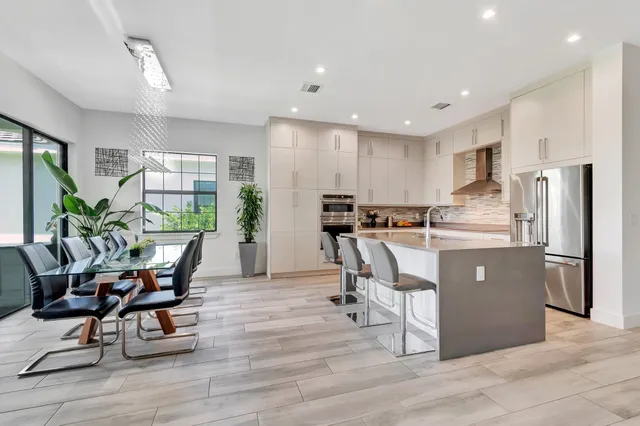 a dining room with furniture window and wooden floor