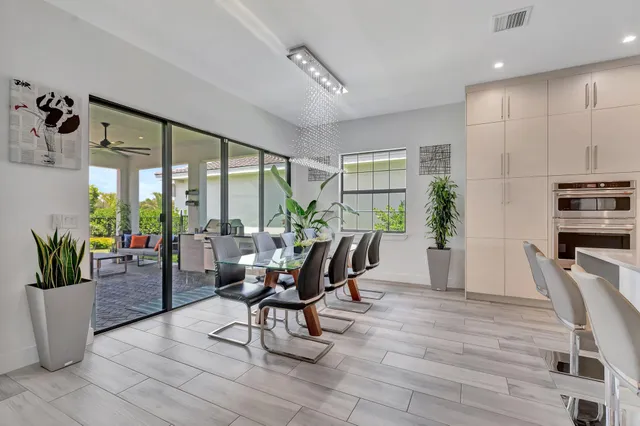 a view of a dining room with furniture and a potted plant