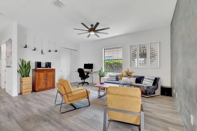 a living room with furniture tv and a large window