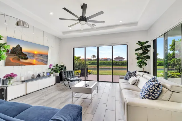 a living room with furniture and a floor to ceiling window