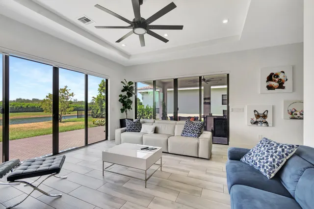 a living room with furniture a large window with outer view