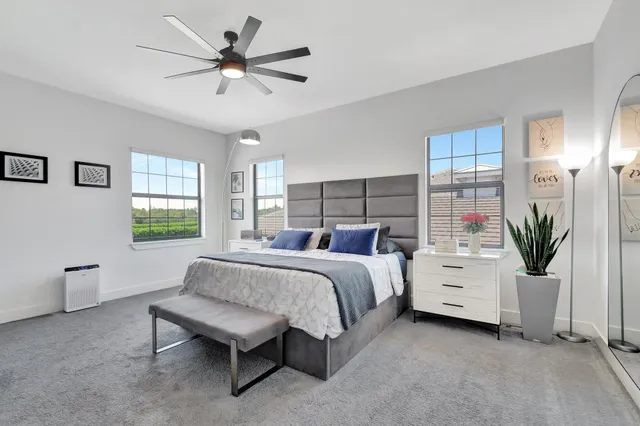 a bathroom with a bathtub a double vanity sink a mirror and a window