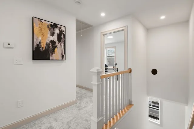 a view of a hallway with a book and a rug