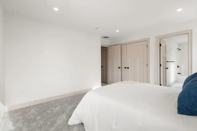 a large white bed in a white room