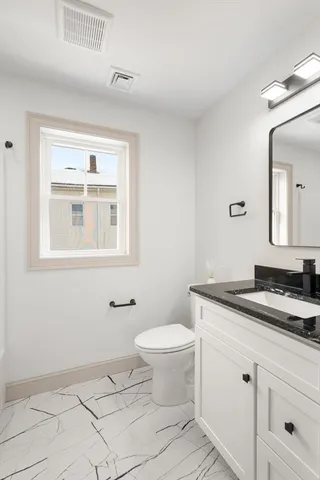 a workspace room with furniture and window