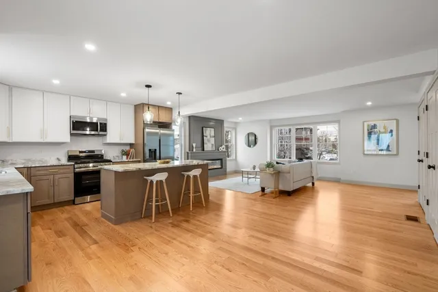 a kitchen with a refrigerator and a stove top oven