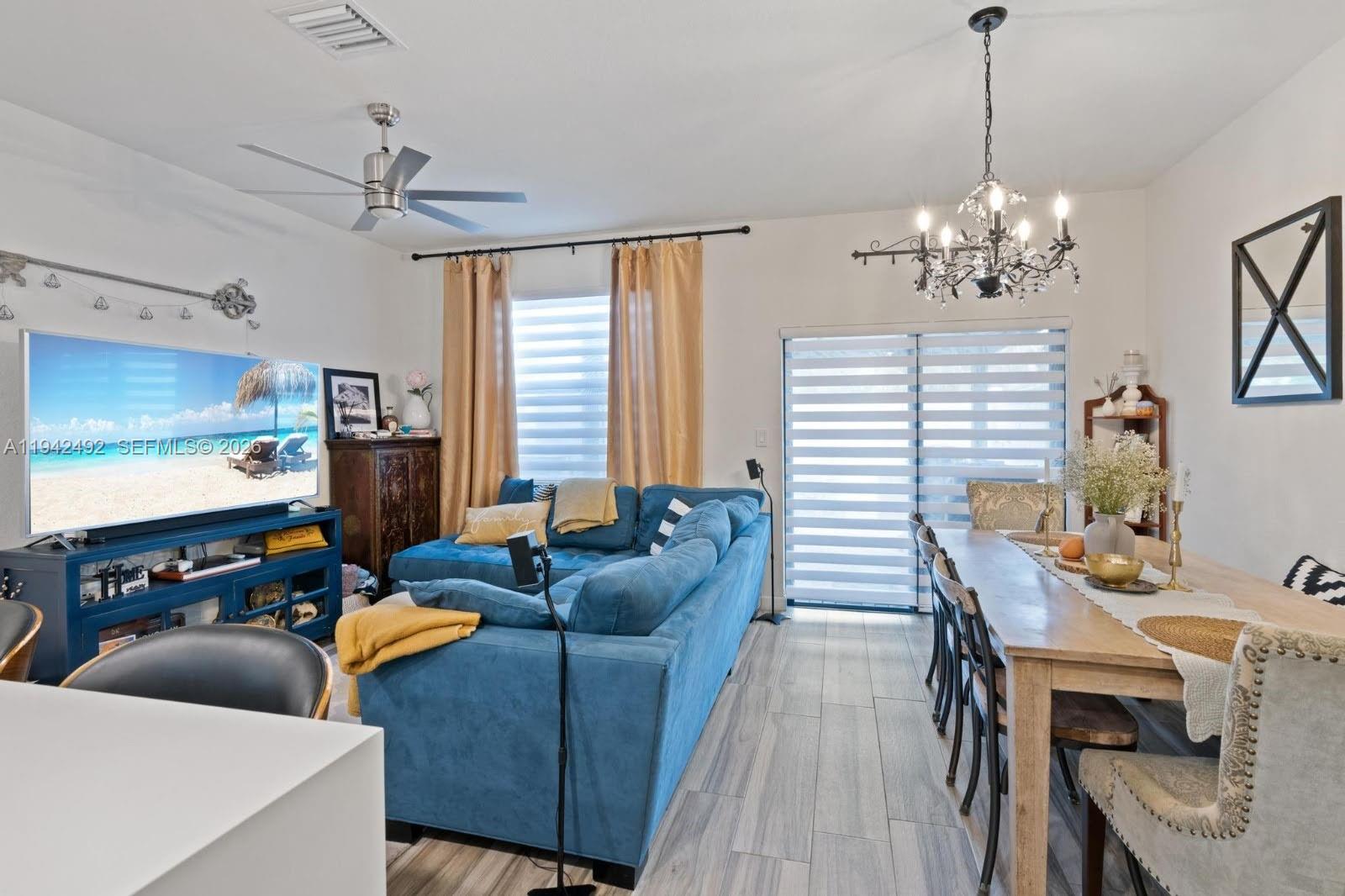 3304 West 92nd Place Hialeah, FL 33018 - Photo 11 of 34 a living room with furniture and a flat screen tv