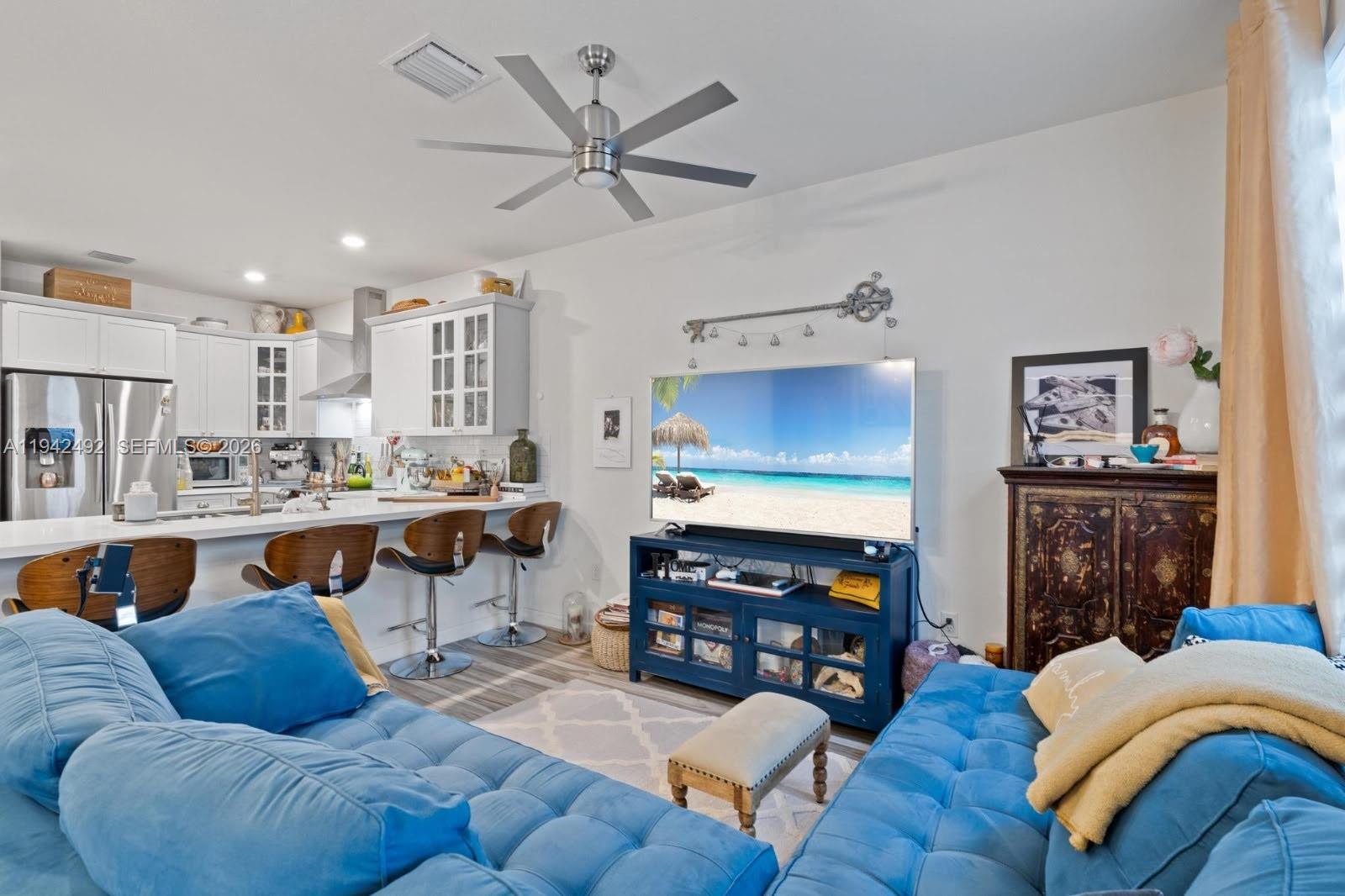 3304 West 92nd Place Hialeah, FL 33018 - Photo 13 of 34 a living room with furniture kitchen view and a fireplace