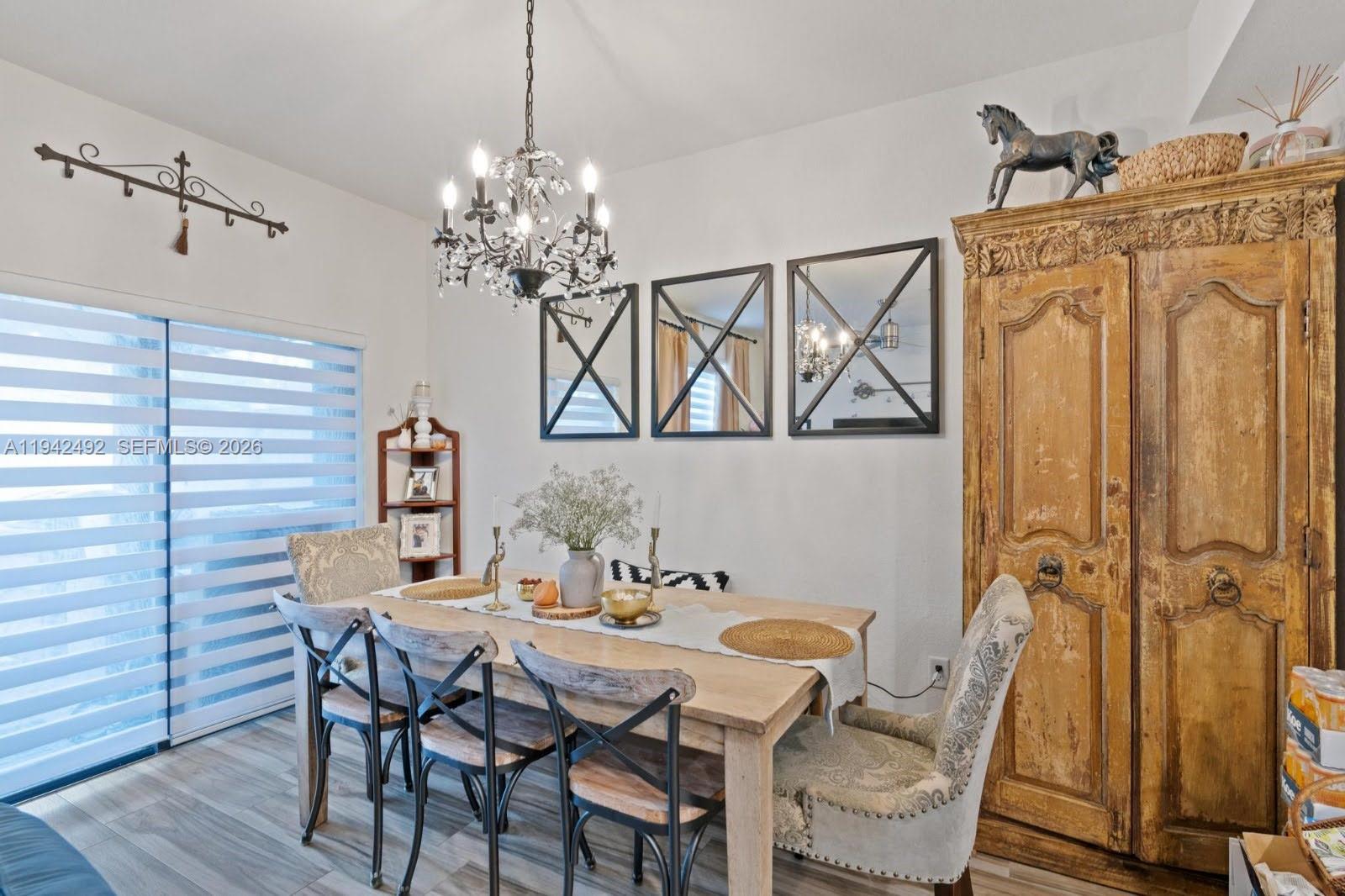 3304 West 92nd Place Hialeah, FL 33018 - Photo 15 of 34 a view of a dining room with furniture and a chandelier