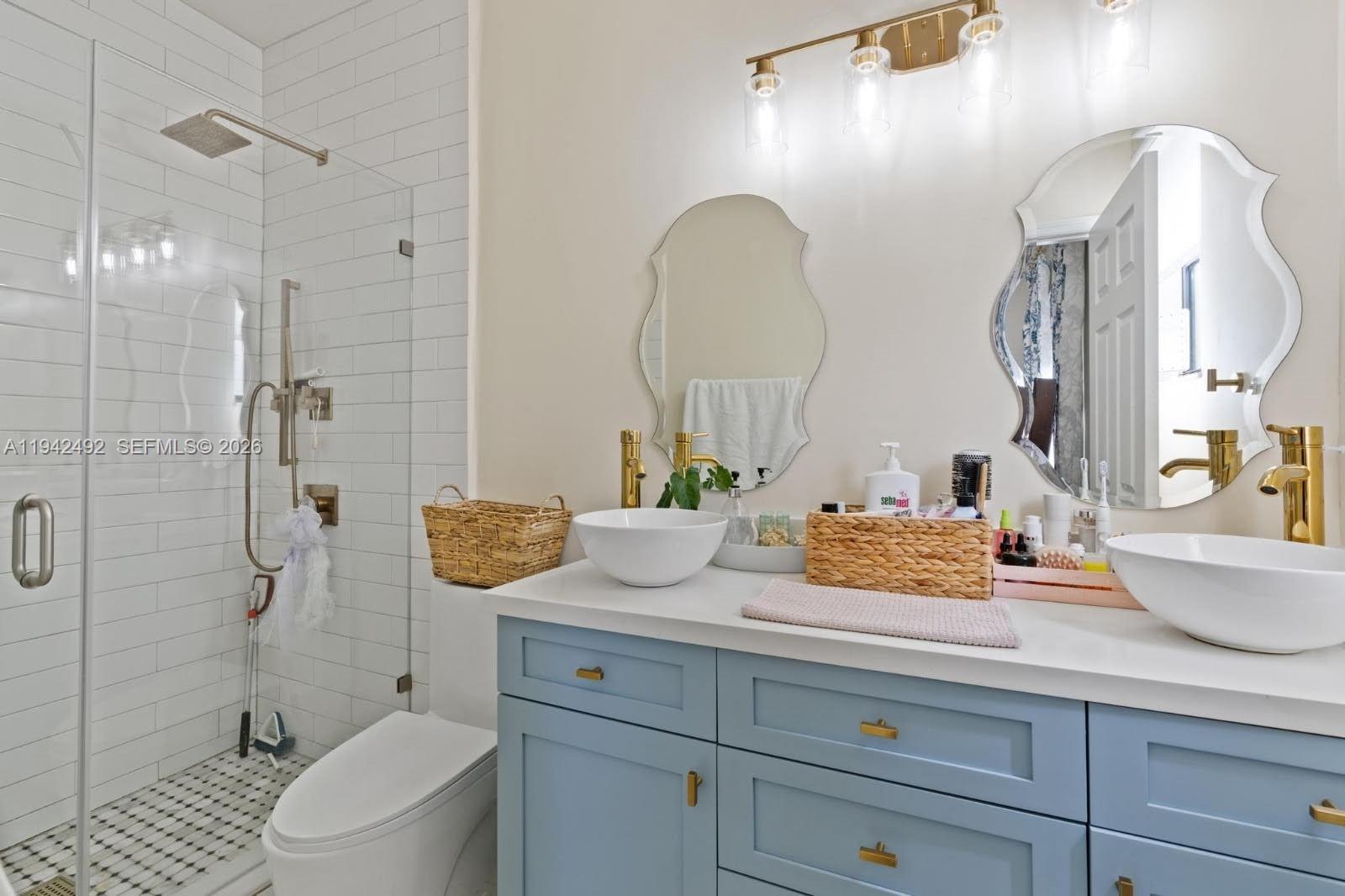 3304 West 92nd Place Hialeah, FL 33018 - Photo 17 of 34 a bathroom with a granite countertop sink a toilet and shower