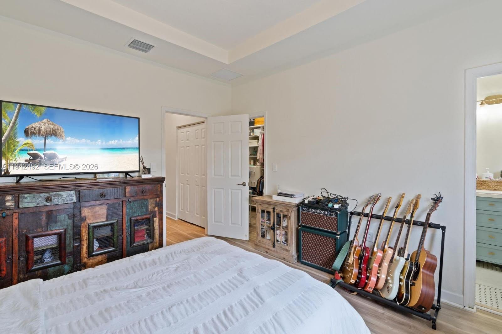 3304 West 92nd Place Hialeah, FL 33018 - Photo 18 of 34 a bedroom with furniture and a book shelf