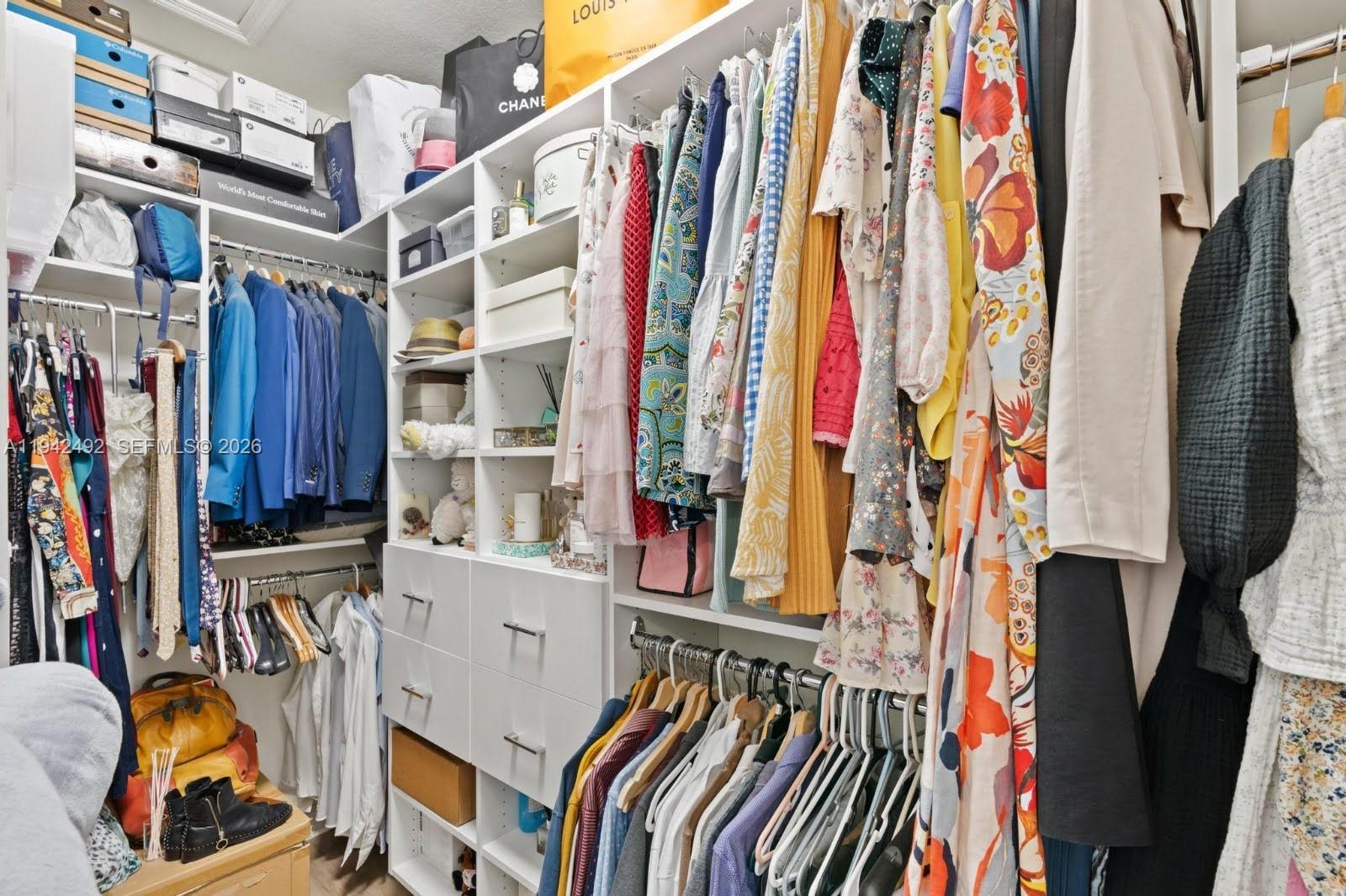 3304 West 92nd Place Hialeah, FL 33018 - Photo 19 of 34 a view of walk in closet with clothes