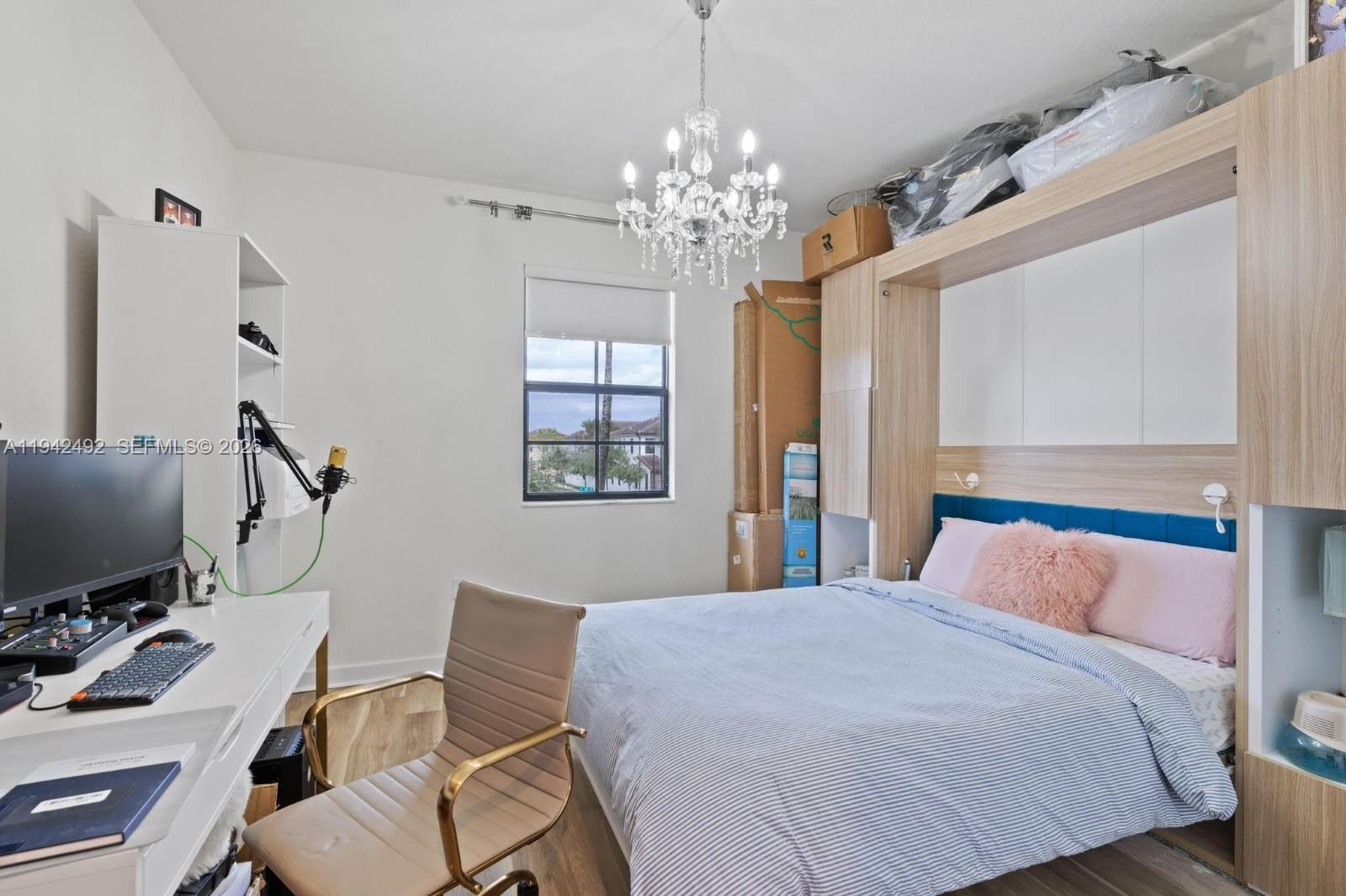 3304 West 92nd Place Hialeah, FL 33018 - Photo 21 of 34 a bedroom with a bed window and a flat screen tv