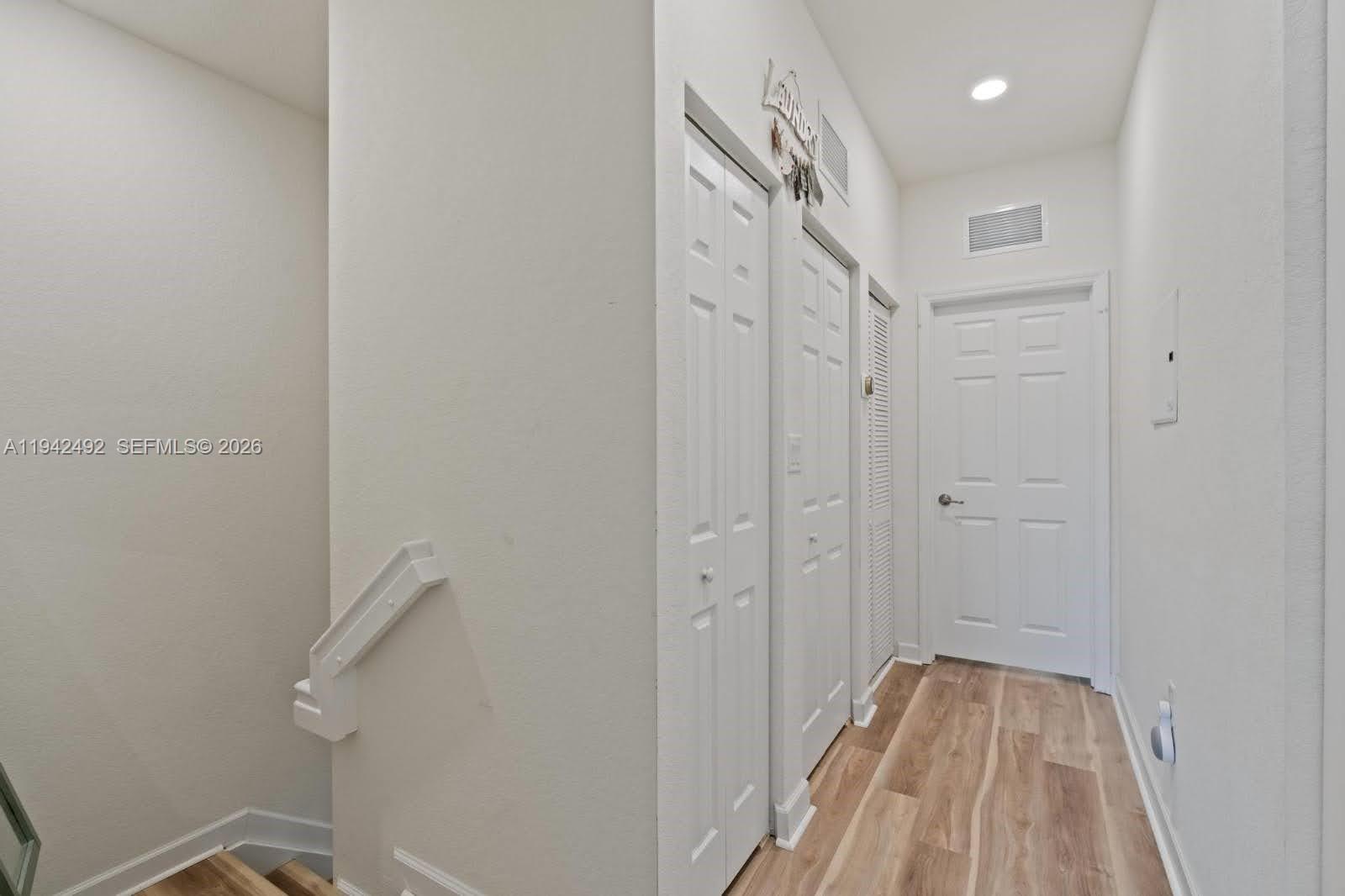 3304 West 92nd Place Hialeah, FL 33018 - Photo 25 of 34 a view of a hallway with wooden floor and a hallway