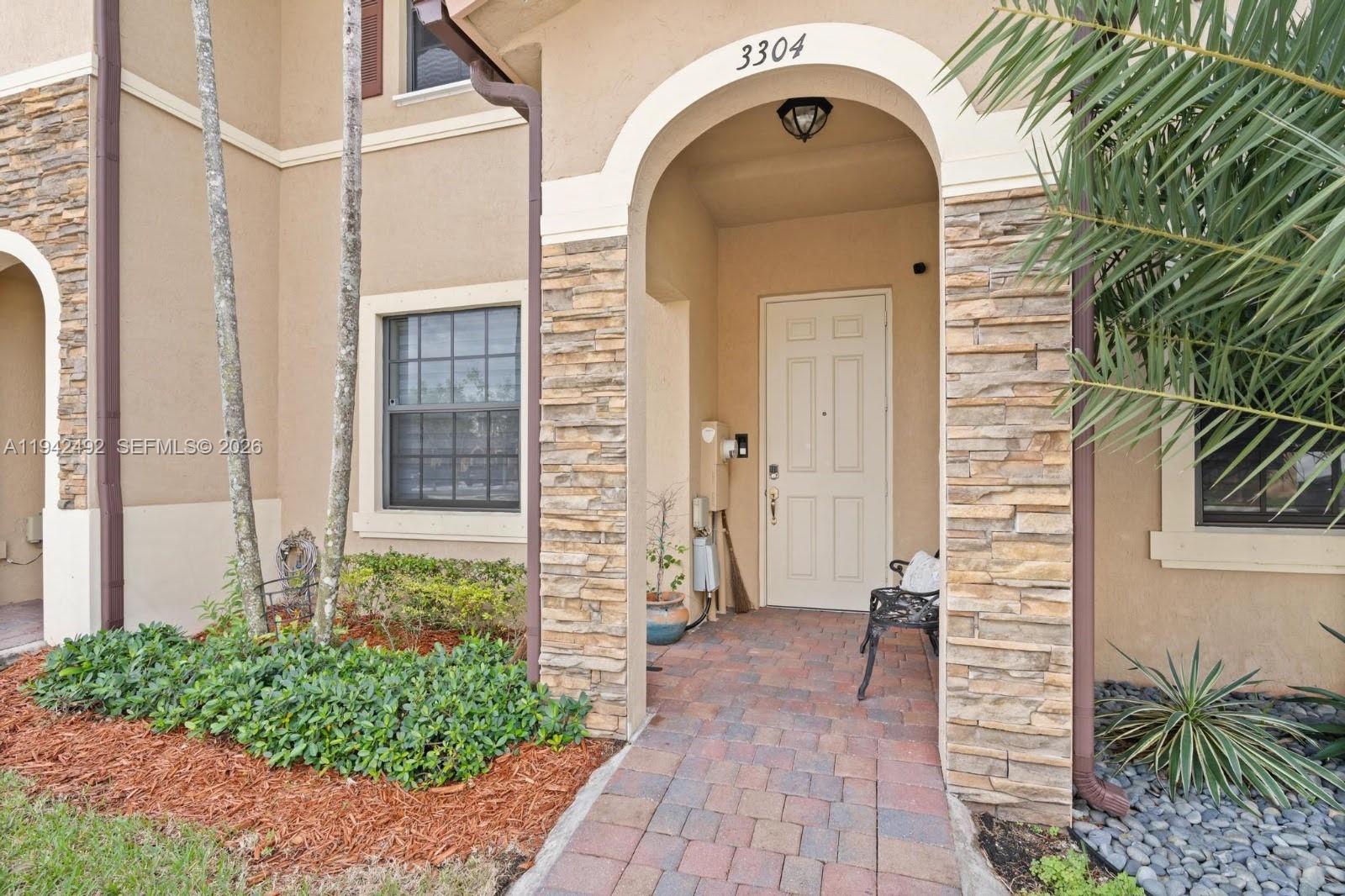 3304 West 92nd Place Hialeah, FL 33018 - Photo 3 of 34 a front view of a house with a garden