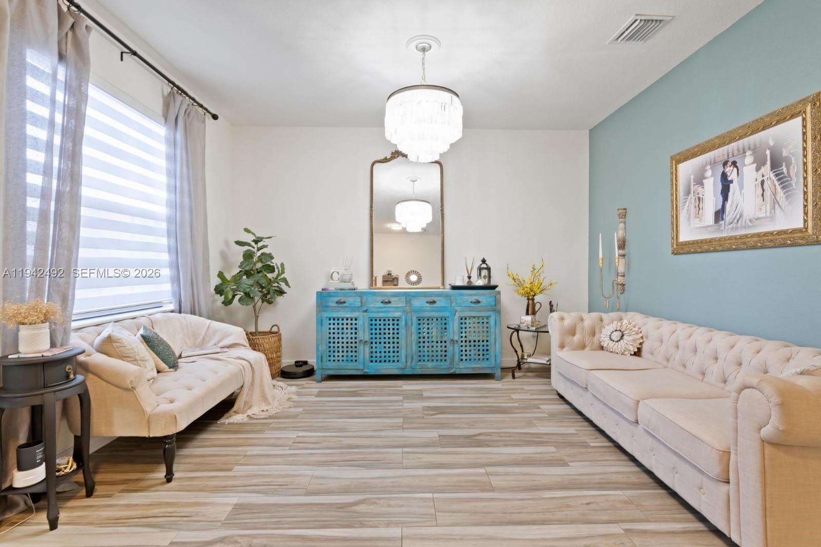 3304 West 92nd Place Hialeah, FL 33018 - Photo 5 of 34 a living room with furniture and a large mirror