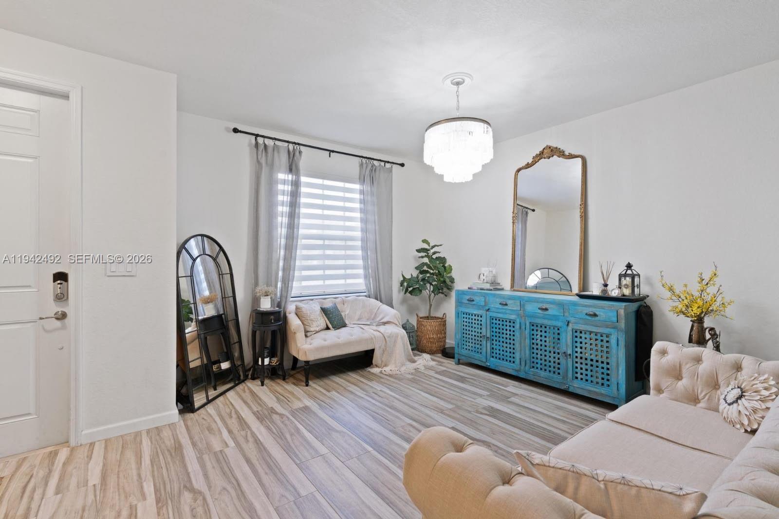 3304 West 92nd Place Hialeah, FL 33018 - Photo 7 of 34 a living room with furniture and a wooden floor