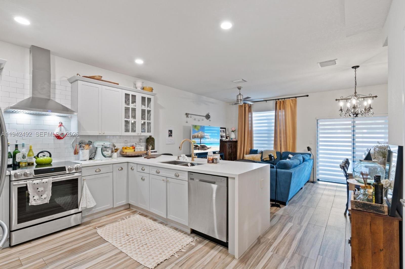 3304 West 92nd Place Hialeah, FL 33018 - Photo 9 of 34 a kitchen with a sink stove and cabinets