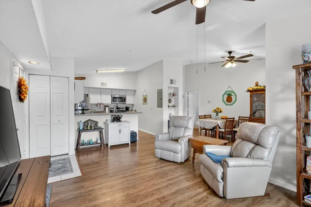 a living room with furniture and a wooden floor