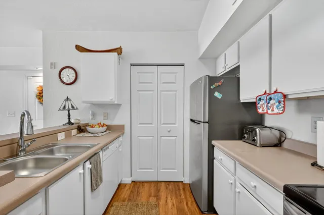 a kitchen with a sink and a refrigerator