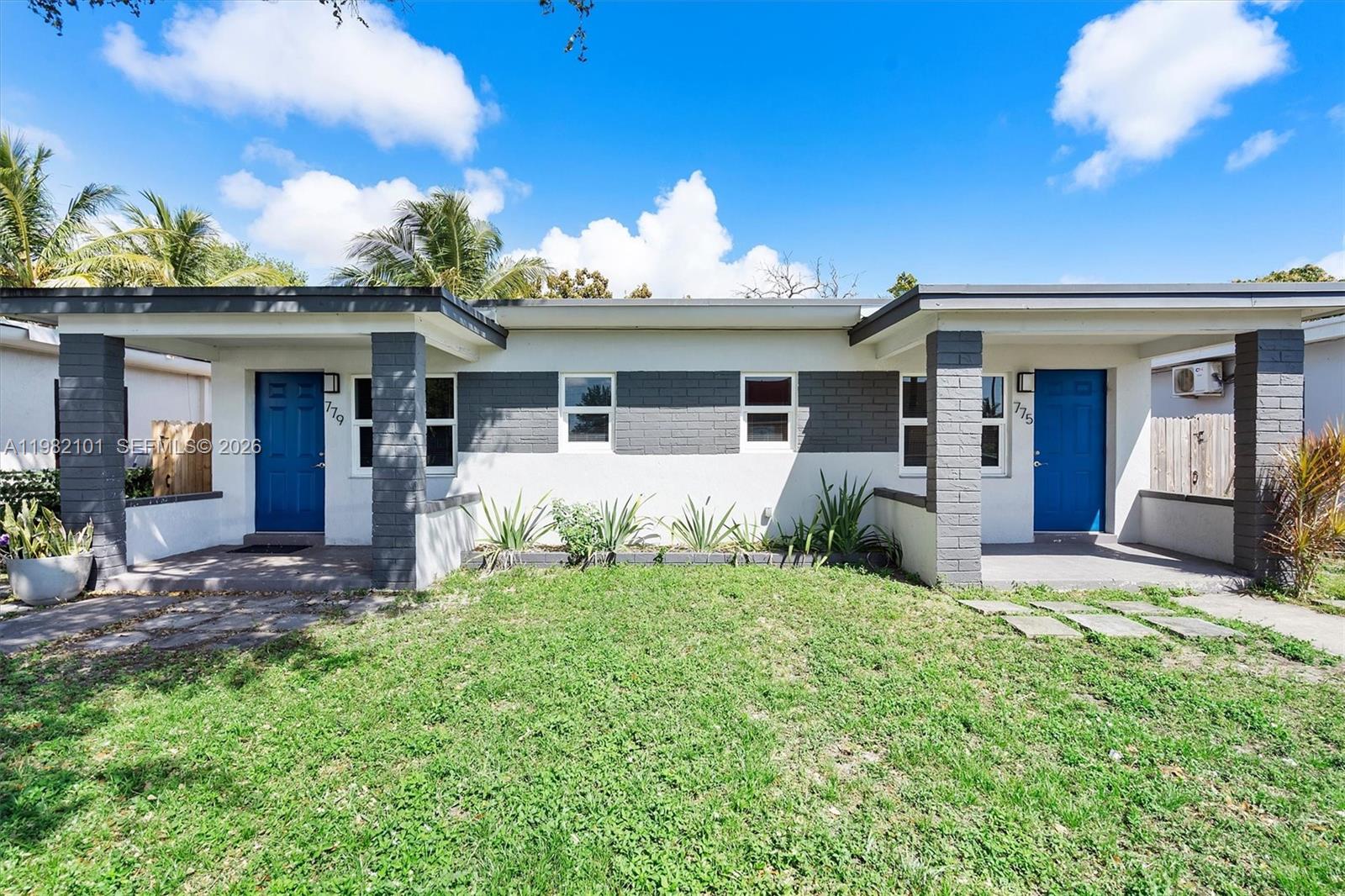 775 Northwest 96th Street, Unit B Miami, FL 33150 - Photo 1 of 9 a view of a house with a yard and potted plants