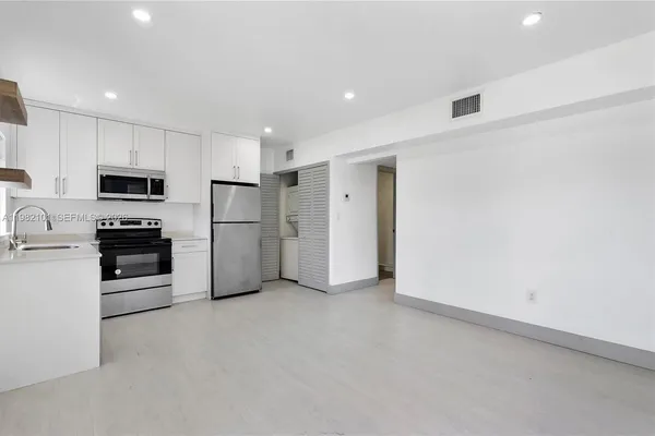 a kitchen with stainless steel appliances a refrigerator and a stove top oven