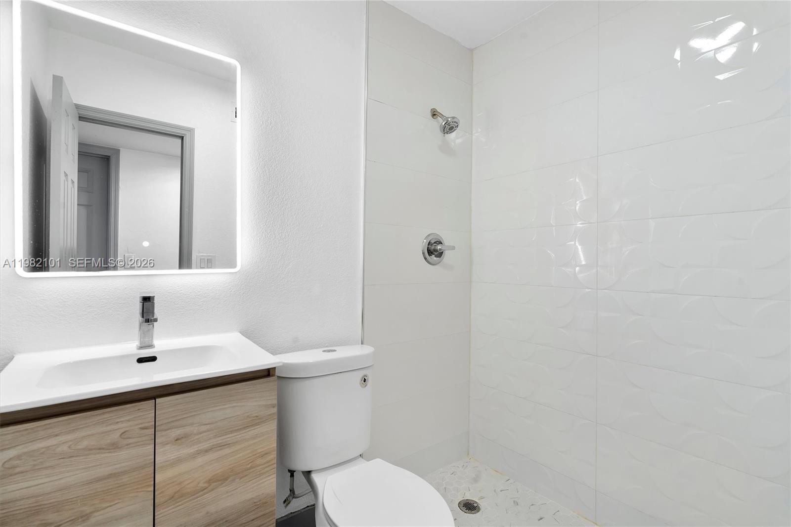 775 Northwest 96th Street, Unit B Miami, FL 33150 - Photo 4 of 9 a bathroom with a sink a toilet and shower