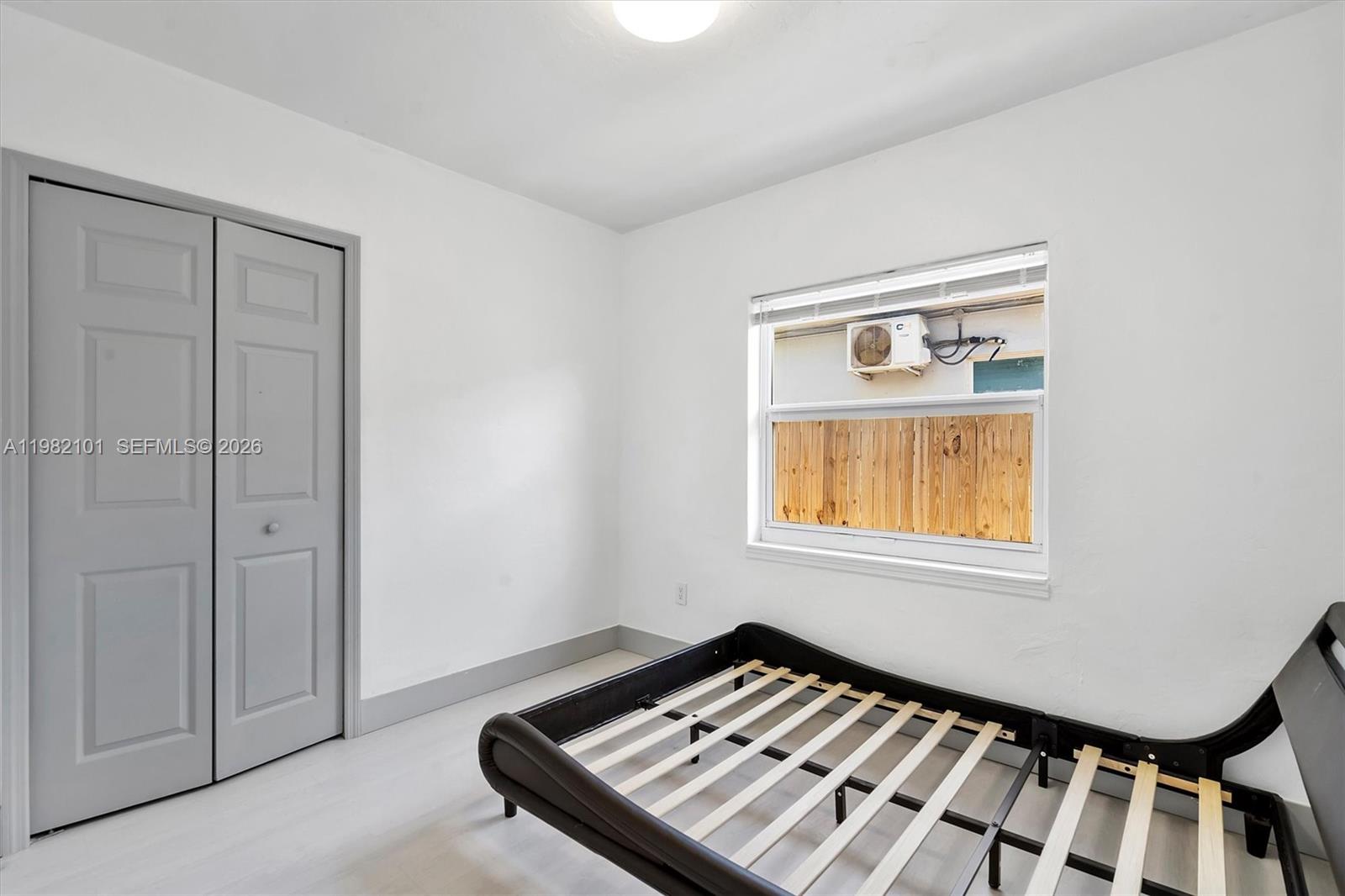 775 Northwest 96th Street, Unit B Miami, FL 33150 - Photo 6 of 9 a view of an empty room and window