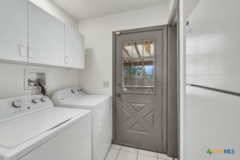 313 Armstrong Street San Marcos, TX 78666 - Photo 11 of 25 a utility room with dryer and washer