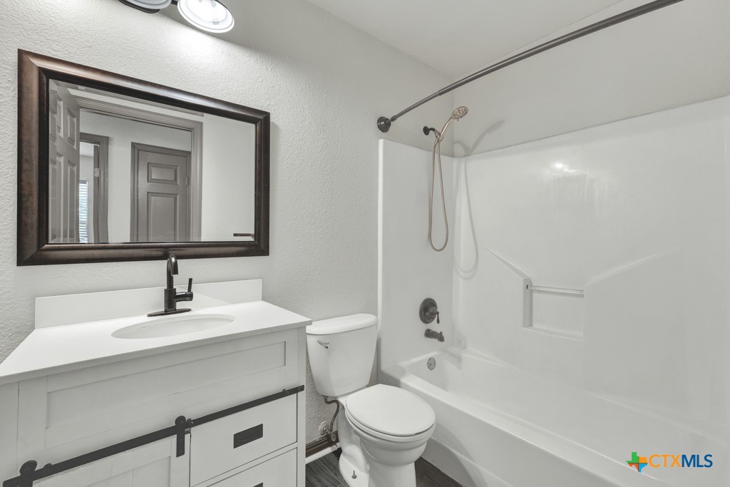 313 Armstrong Street San Marcos, TX 78666 - Photo 16 of 25 a bathroom with a sink toilet and shower