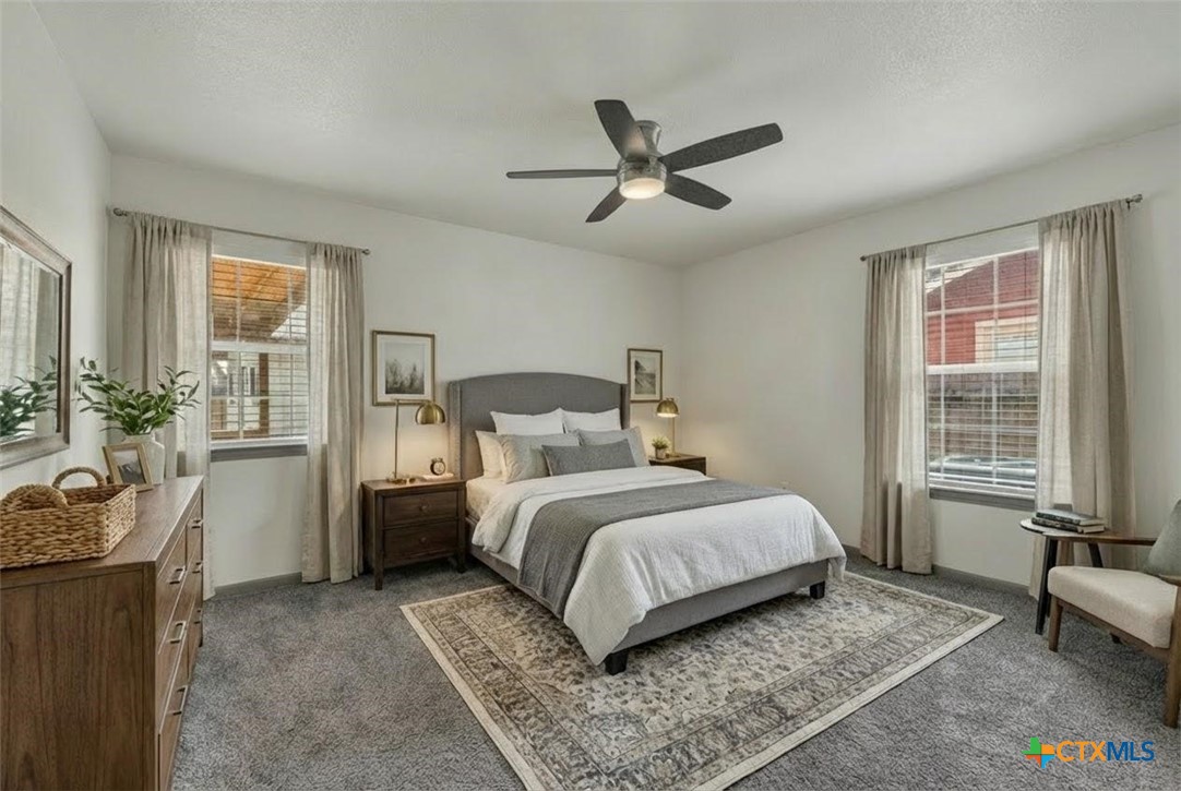 313 Armstrong Street San Marcos, TX 78666 - Photo 18 of 25 a bedroom with a bed a couch and a window