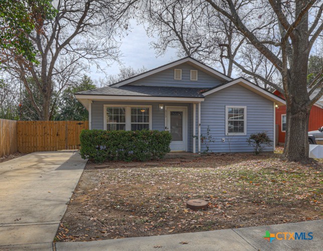 313 Armstrong Street San Marcos, TX 78666 - Photo 2 of 25 a front view of a house with yard