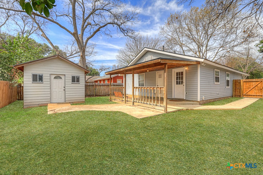 313 Armstrong Street San Marcos, TX 78666 - Photo 23 of 25 a front view of a house with a garden and yard