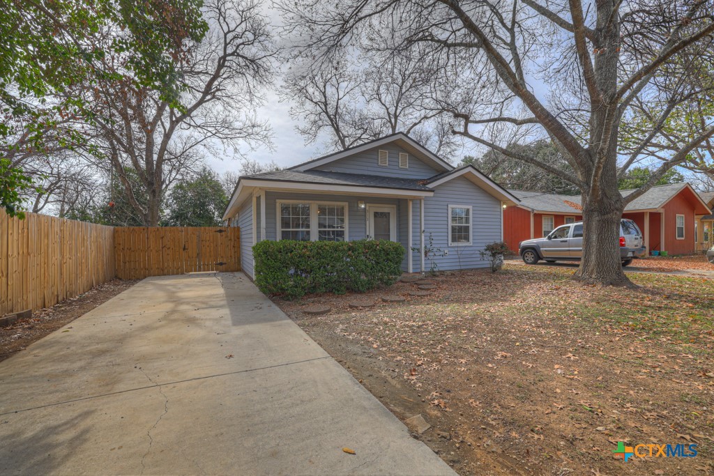 313 Armstrong Street San Marcos, TX 78666 - Photo 3 of 25 a front view of a house with a yard and trees
