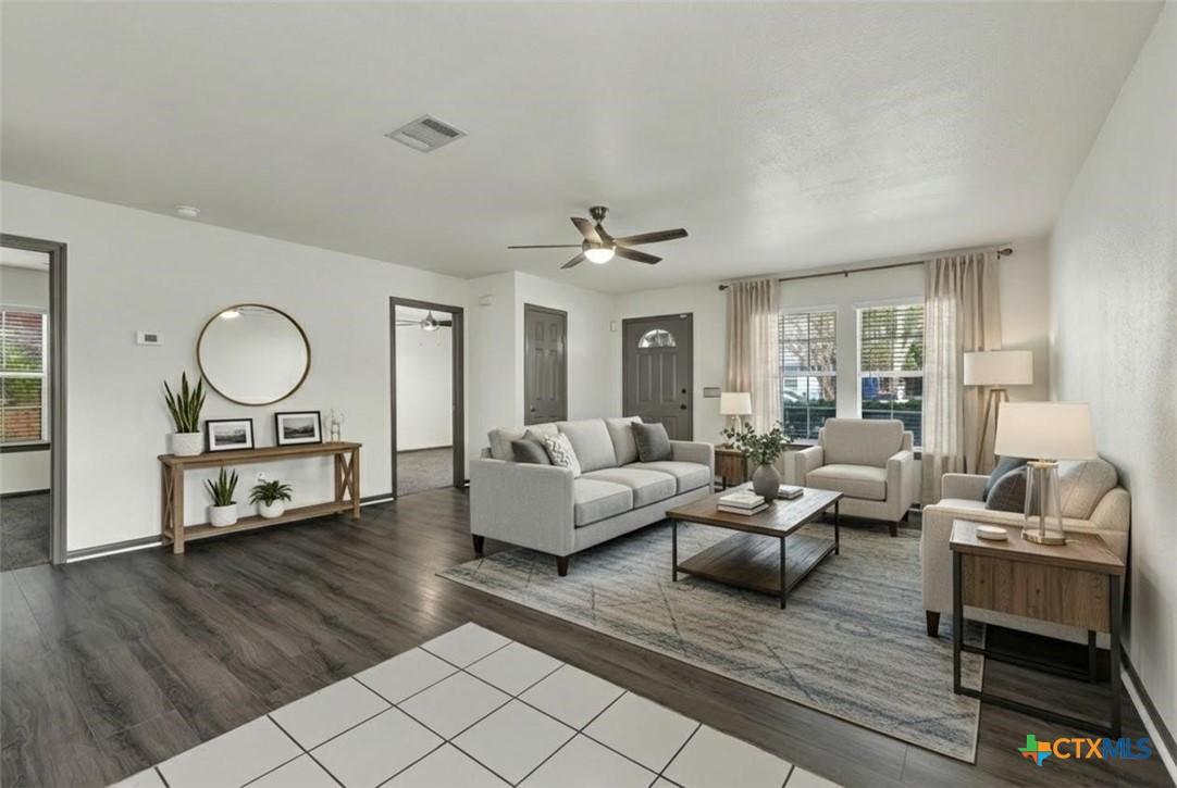 313 Armstrong Street San Marcos, TX 78666 - Photo 5 of 25 a living room with furniture and a large mirror next to a window