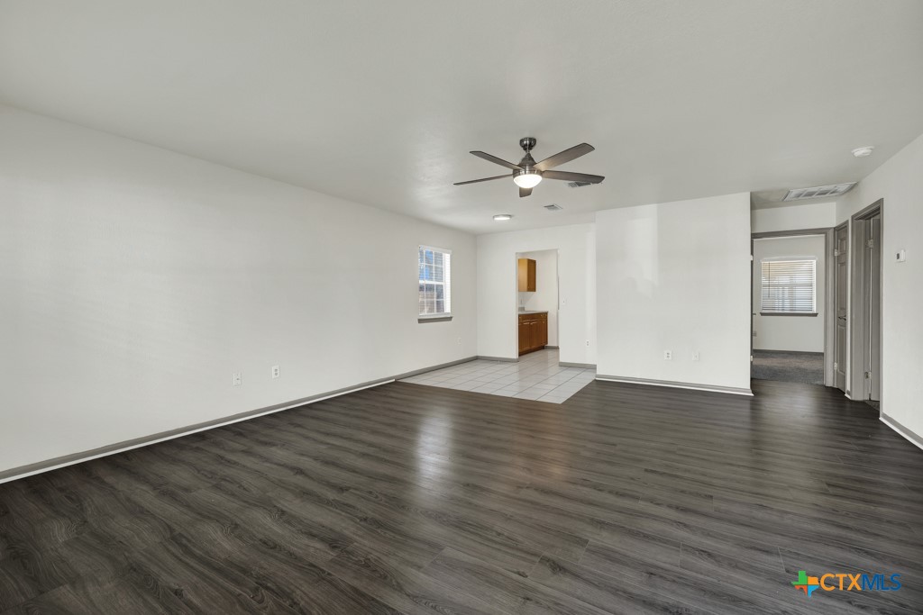 313 Armstrong Street San Marcos, TX 78666 - Photo 6 of 25 a view of an empty room with window and wooden floor