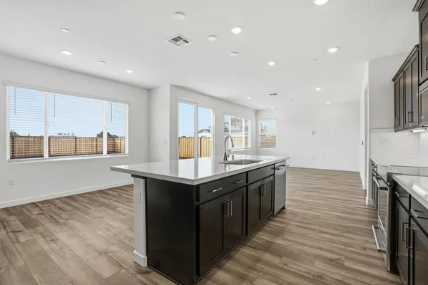 a kitchen with stainless steel appliances granite countertop a stove and a sink