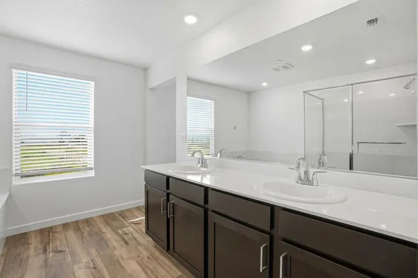 a bathroom with a sink double vanity and a mirror