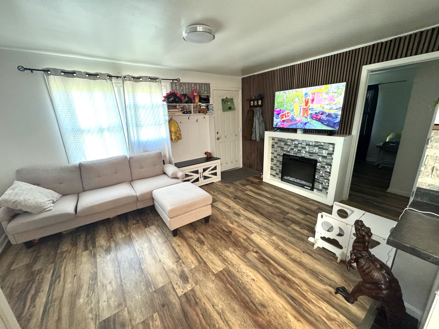 931 South Rawson Bridge Road Cary, IL 60013 - Photo 31 of 36 a living room with furniture and a flat screen tv