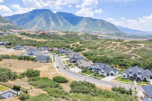 3383 South Mapleton Estates Drive, Unit 18 Mapleton, UT 84664 - Photo 9 of 11 Expansive residential development featuring modern residences situated along a curving street, surrounded by natural terrain with distant mountains