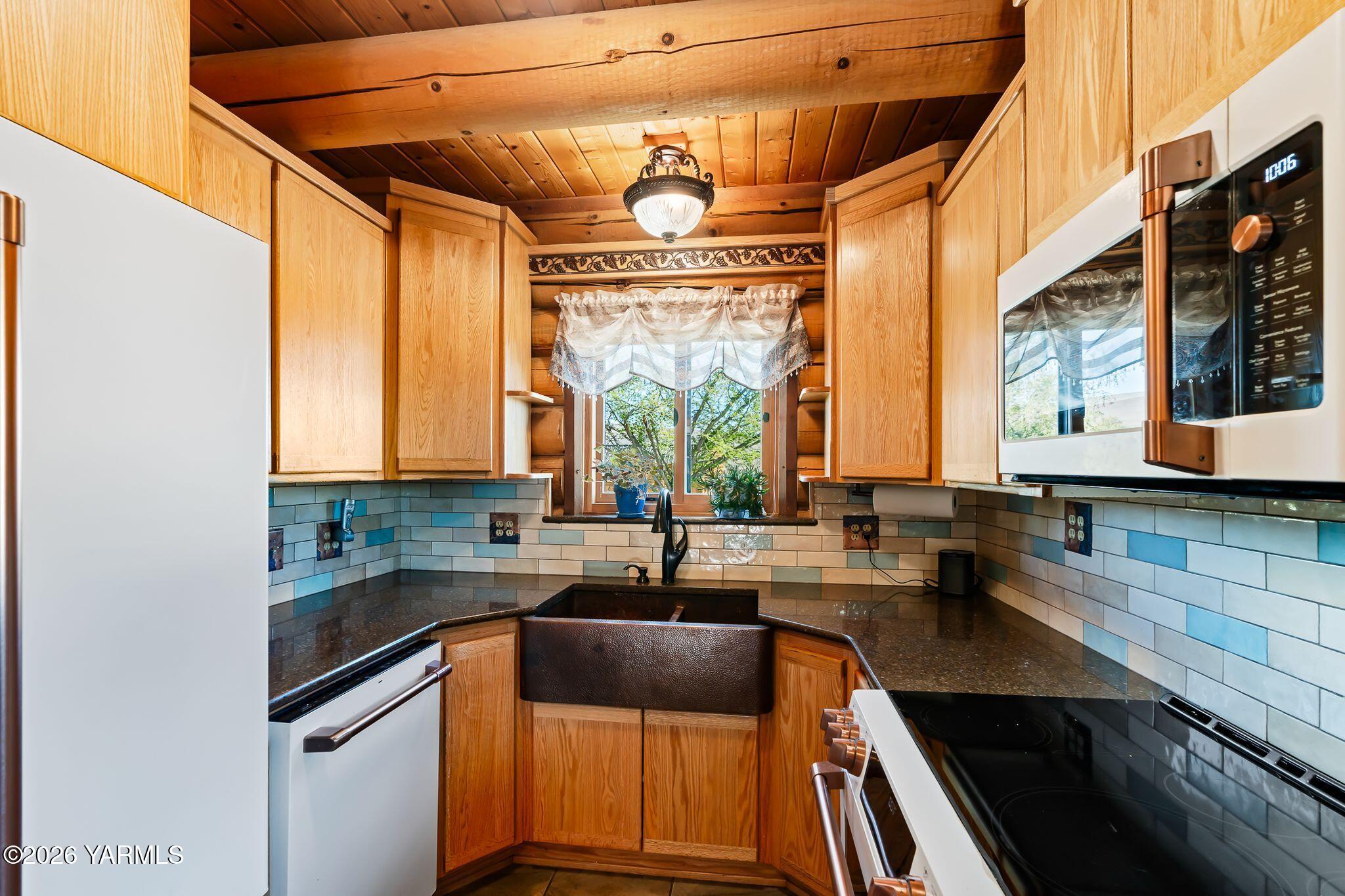 2550 Kays Road Wapato, WA 98951 - Photo 14 of 52 a kitchen with a sink a counter top space cabinets and a window