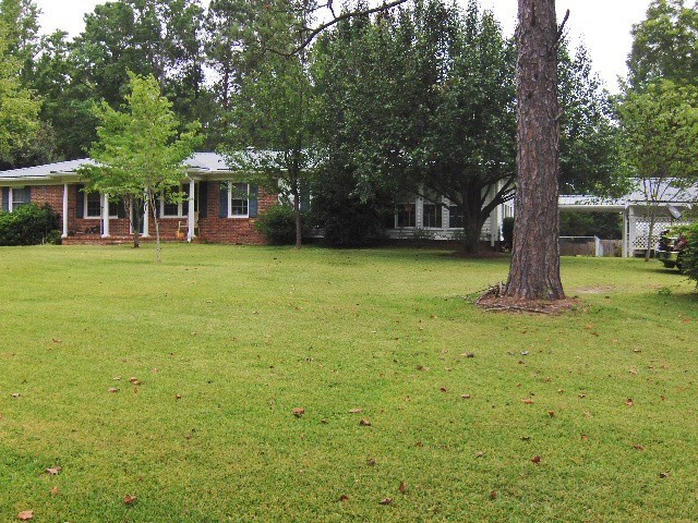 1235 Girl Scout Road Lizella, GA 31052 - Photo 1 of 29 a front view of a house with a garden