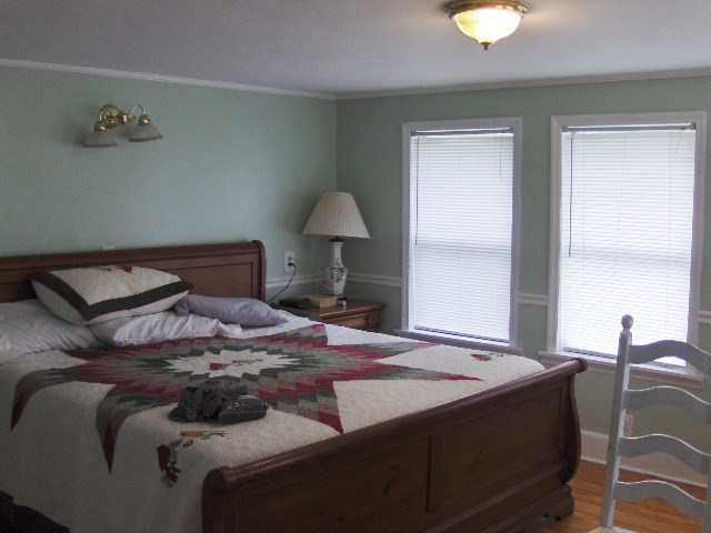 1235 Girl Scout Road Lizella, GA 31052 - Photo 15 of 29 a bedroom with a bed and a lamp