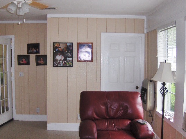 1235 Girl Scout Road Lizella, GA 31052 - Photo 20 of 29 a blue couch sitting in a kitchen next to a window