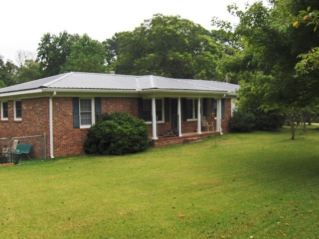 1235 Girl Scout Road Lizella, GA 31052 - Photo 3 of 29 a view of a house with backyard garden and trees