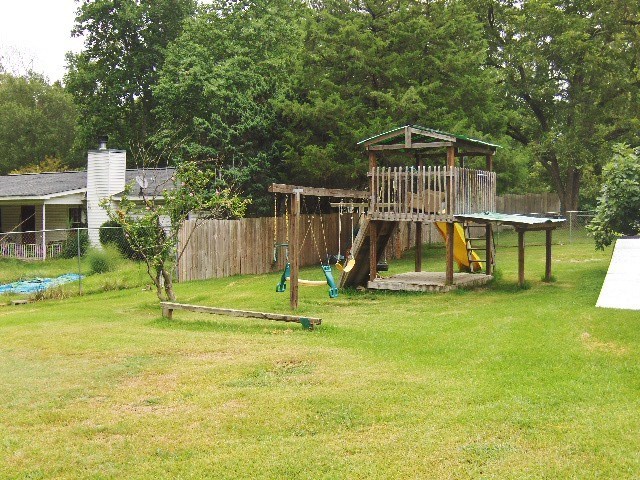 1235 Girl Scout Road Lizella, GA 31052 - Photo 29 of 29 a garden with trees and wooden fence