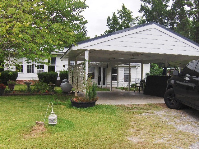 1235 Girl Scout Road Lizella, GA 31052 - Photo 4 of 29 a backyard of a house with seating space