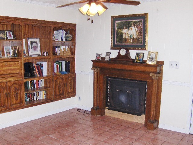 1235 Girl Scout Road Lizella, GA 31052 - Photo 8 of 29 a living room with bookshelf and a fireplace